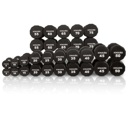 Collection of XMARK 12-sided urethane dumbbells ranging from 5 to 75 lbs, featuring clear weight markings and a sturdy design.
