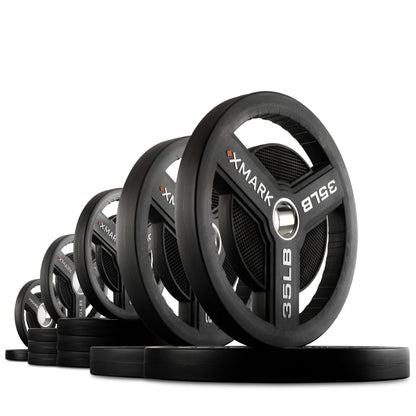 Line of XMARK Commercial Urethane Olympic Weight Plates with tri-grip handles, showcasing durability and precision.