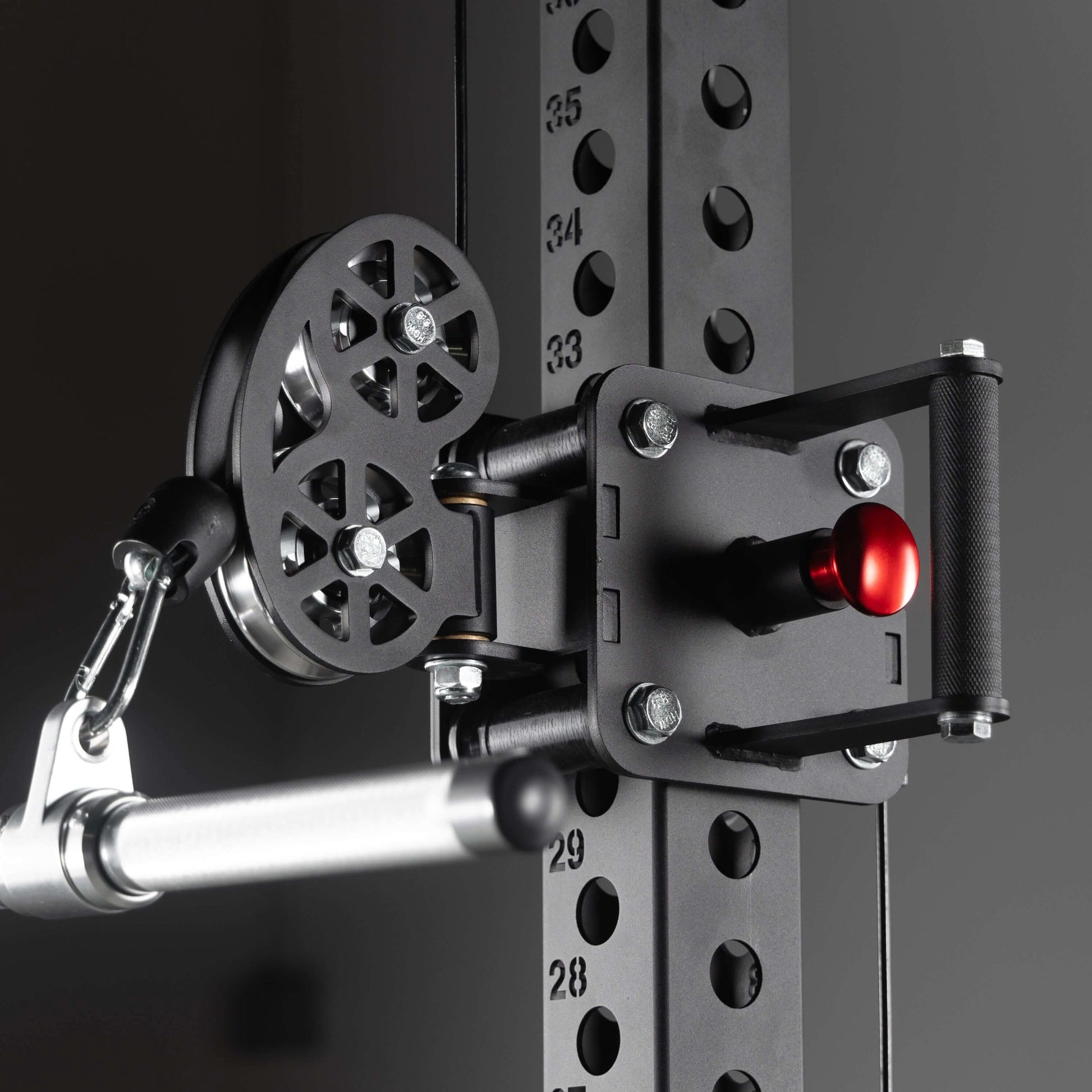 Close-up of a commercial half rack functional trainer pulley system with adjustable handles and robust metallic frame.