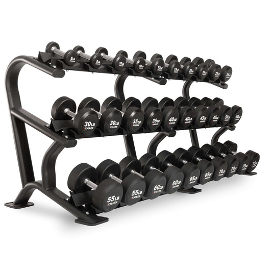 XMARK round commercial urethane dumbbells set on rack, ranging from 5 to 75 lbs for strength training.