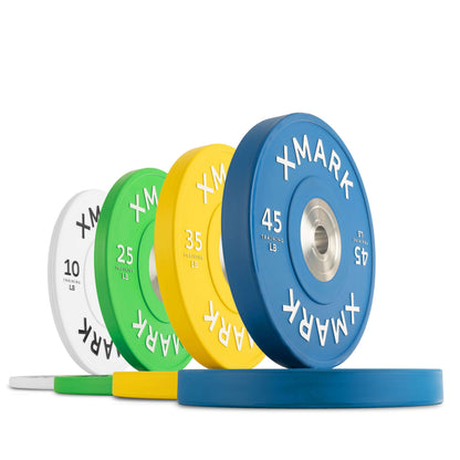 Colorful XMARK bumper plates in various weights (10, 25, 35, 45 lbs) on a white background, showcasing premium rubber design.