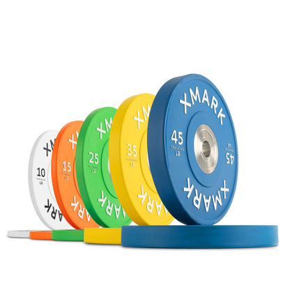 Colorful commercial virgin rubber bumper plates in various weights for gym use, showcasing durability and visual appeal.