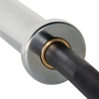 Close-up of a Crowbar EZ Curl Barbell showing chrome sleeve, brass collar, and textured black handle.