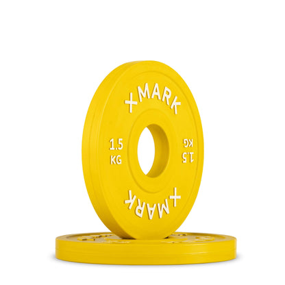 Yellow 1.5 kg Olympic change plate with raised lettering and center hole for barbell use.