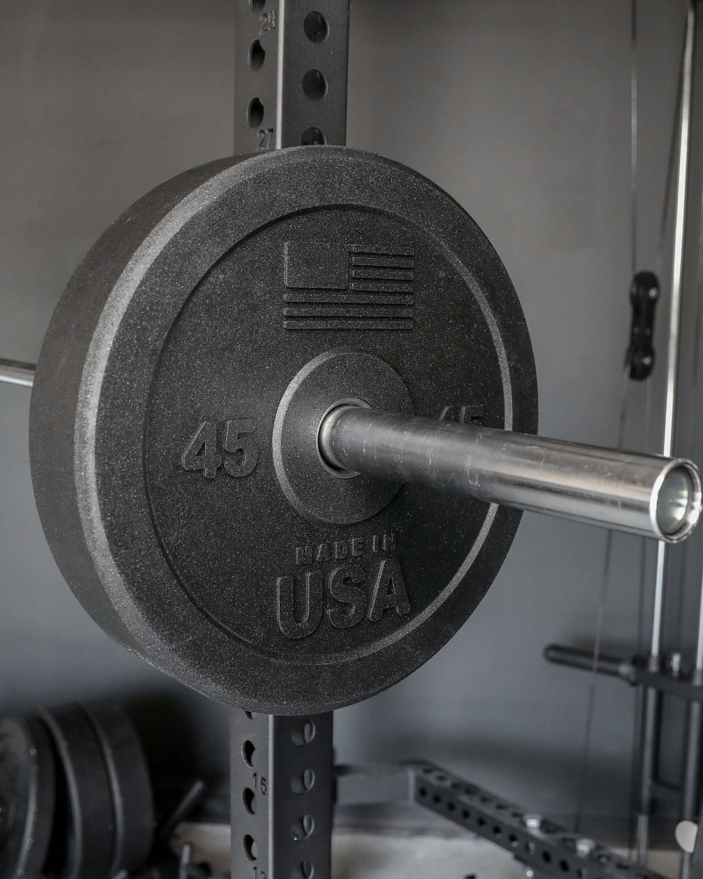 USA Bumper Plates - close up view with plate on a barbell (45 lbs)