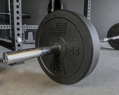USA Bumper Plate Set - close up view with plate on a barbell on the ground (45 lbs)