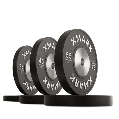 Black premium training bumper plates in various weights, showcasing durability and precise engineering for weight lifting.
