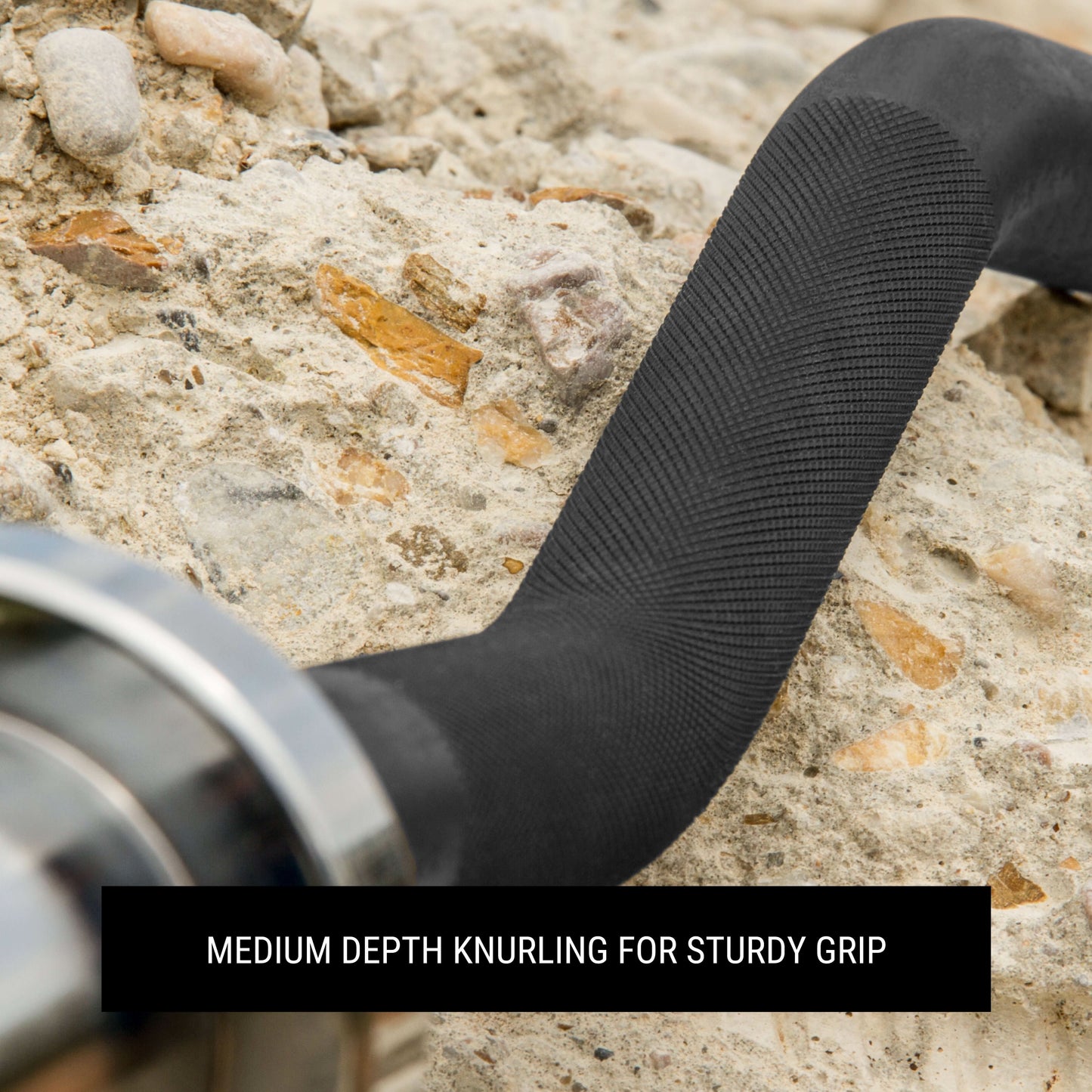 Close-up of a barbell handle showing medium depth knurling for solid grip on a textured surface.