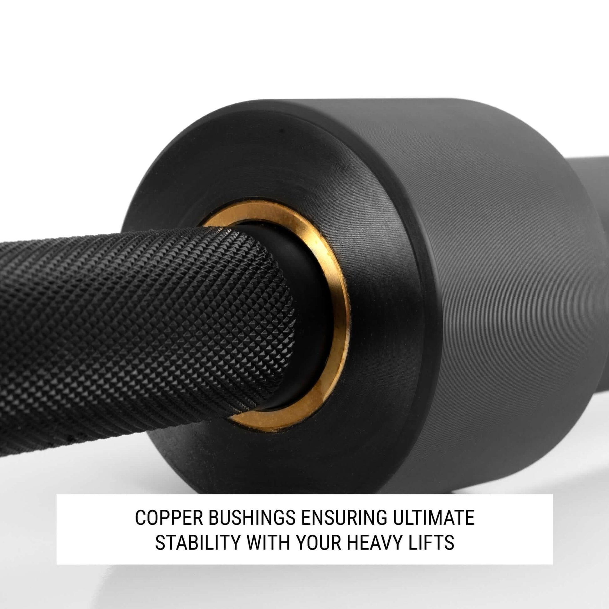 Close-up of squat bar showing copper bushings for stability during heavy lifts.