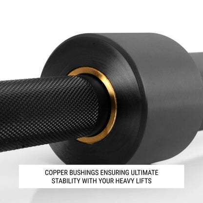Close-up of squat bar showing copper bushings for stability during heavy lifts.