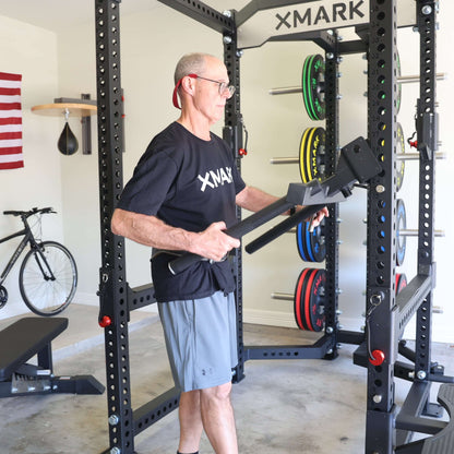 A man demonstrates the Viper Triceps Dip Handle Attachment on a power rack, emphasizing stability and functionality.