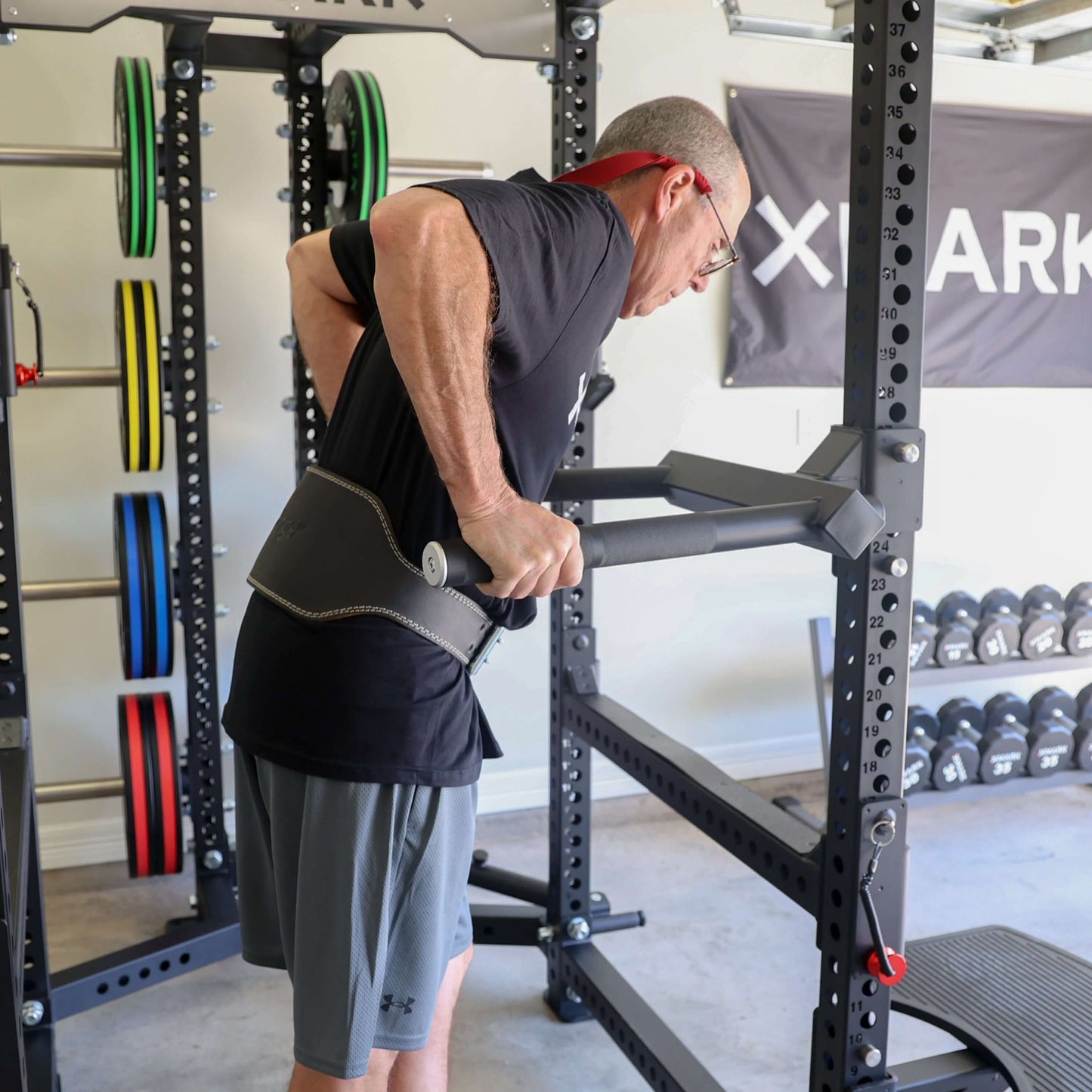 A man doing triceps dips using the Viper Dip Handle Attachment on a power rack, showcasing stability and balance.
