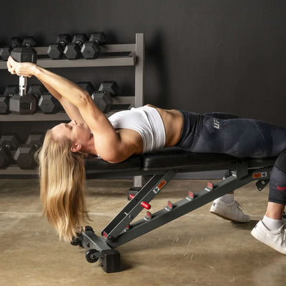Woman using an adjustable FID weight bench for fitness training, showcasing versatility and comfort.