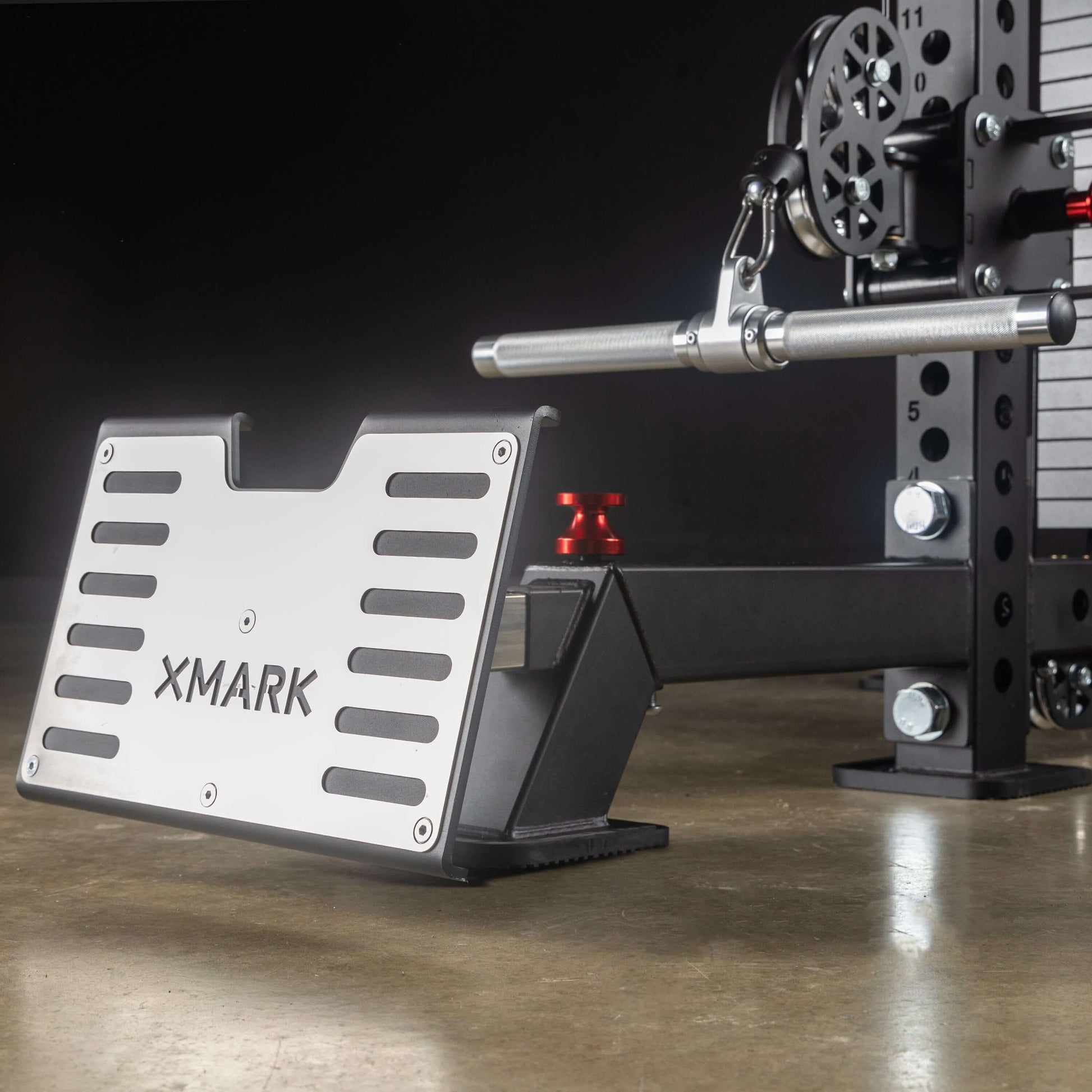 Close-up of Xmark low row footplate on a functional trainer, showcasing heavy-duty design and adjustable features.
