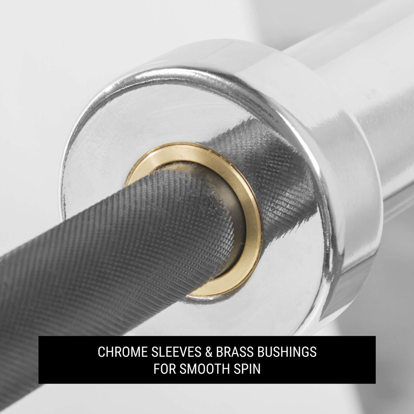 Close-up of chrome sleeves and brass bushings on a barbell for smooth spin during lifting.