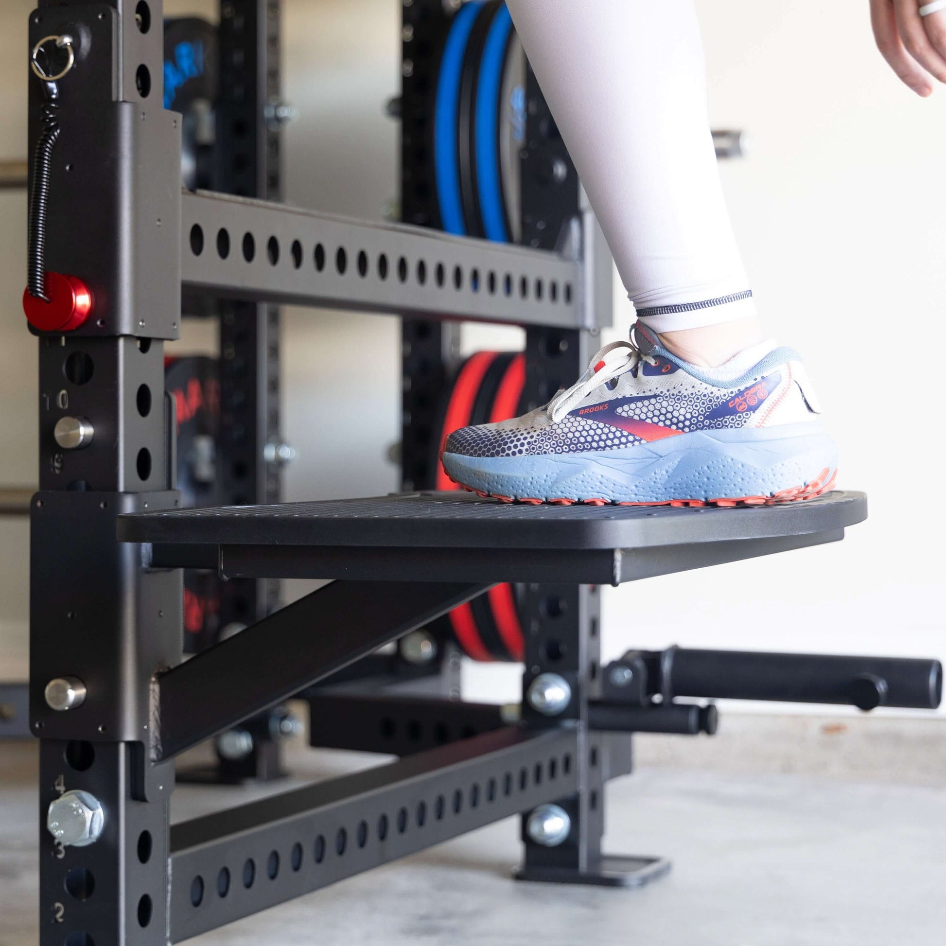 Person stepping onto a heavy duty Viper Multi-Purpose Step Attachment for fitness exercises.